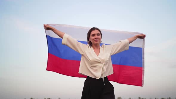 Portrait of a Russian Beautiful Woman with the National Flag, Symbol of the Russian Federation