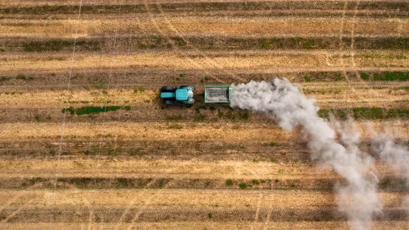 Top view of tractor plowing field in autumn, aerial view alt