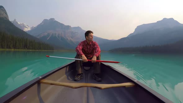 Man sitting on boat in lake 4k alt