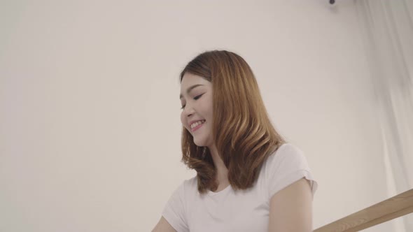 Beautiful young Asian woman traveler packing stuff in suitcase prepare for holiday vacation. alt