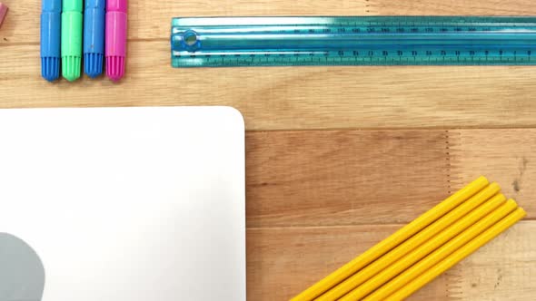 Close-up of laptop with various stationery alt