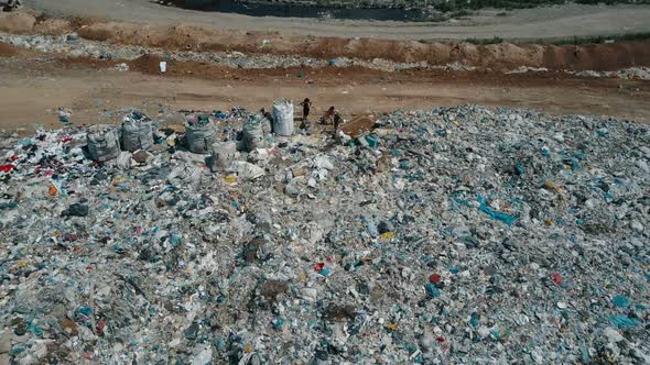 Aerial View of City Garbage Dump. Gulls Feeding on Food Waste Fly Over It. alt