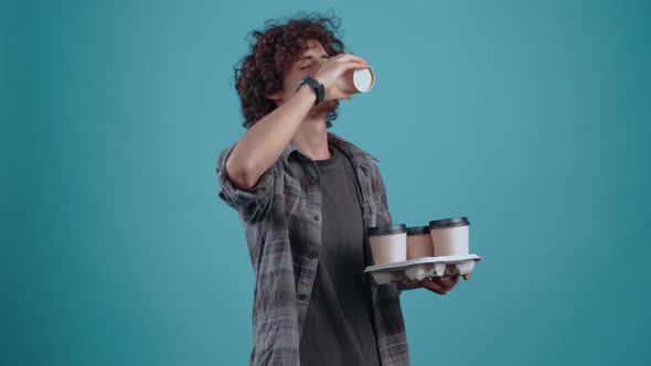 The Charismatic Young Man with Four Glasses of Coffee a Student Takes a Glass From Which He Drinks alt