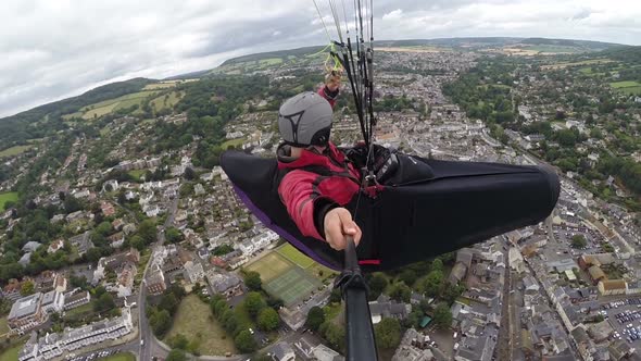 Paraglider Pilot Enjoys Flight Over Coastal Seaside Resort alt