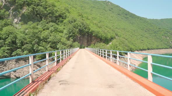 Bridge Over Beautiful Mountain Lake on a Sunny Day alt