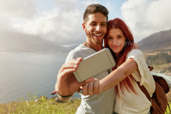 Young couple hiking taking selfie with smart phone - Stock Photo - Images