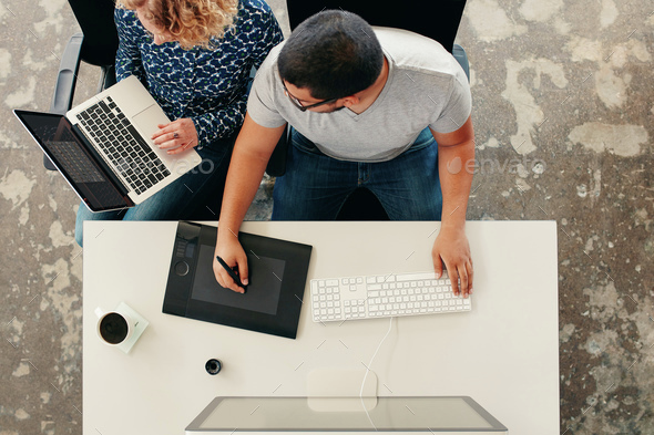 Graphic designers cooperating at work - Stock Photo - Images