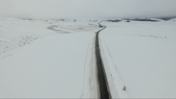Cars Driving On a Winter Road.