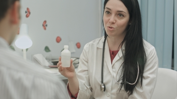 Smiling Female Doctor Recommending Drugs To Patient alt