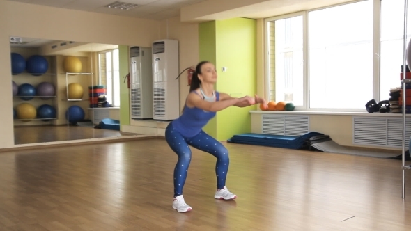Young Athletic Woman Trains In Gym