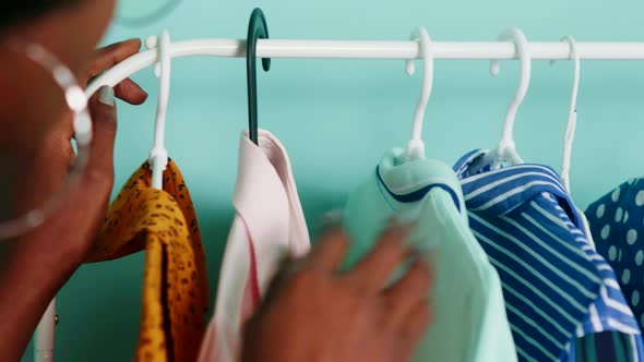Black Woman Is Looking For Summer Clothing on Rack alt