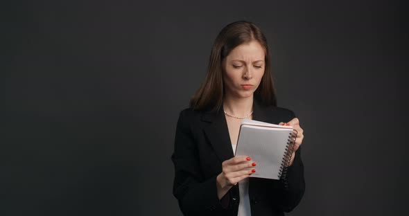 Vexed and Angry Woman in Black Suit Crosses Out Hes Notes in the Notepad  Prores HQ 120 Fps alt