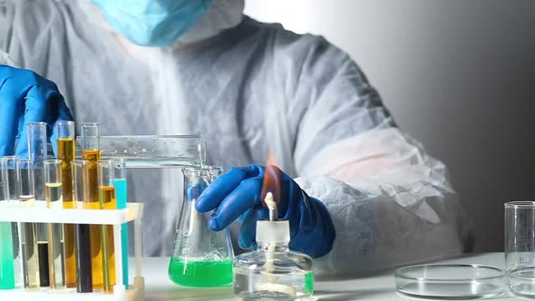 Chemist in laboratory works in chemical reagents alt