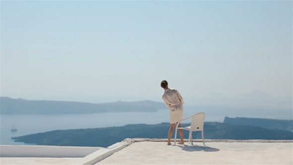 Beautiful Sexy Brunette Bride In Robe Sitting At Roof