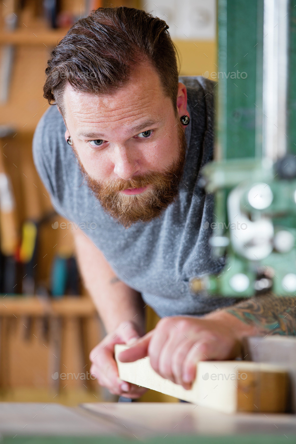 Craftsman using bandsaw for splitting wood plank in workshop Stock ...