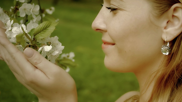 Happy Woman Touching White Flowers
