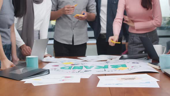 Young Asian business people meeting brainstorming ideas about new paperwork project. alt