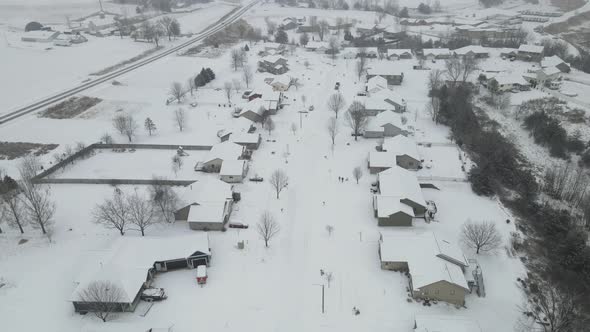 Aerial view of rural snow covered neighborhood in western Wisconsin. Neighborhood in valley.