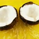 Rotating segments of a ripe and juicy coconut on an orange background. Slow motion. - VideoHive Item for Sale