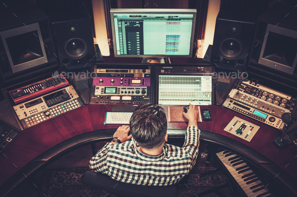Sound engineer working at mixing panel in the boutique recording - Stock Photo - Images