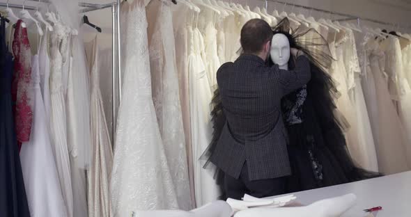 Fashion Designer Trying on an Evening Dress on a Mannequin in Atelier