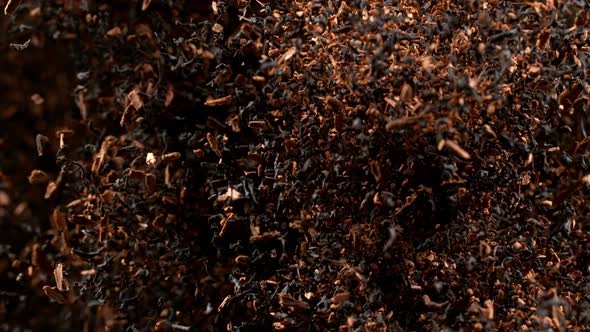 Super Slow Motion Shot of Falling Dried Tea Isolated on Black Background at 1000Fps alt