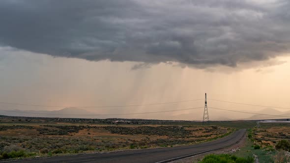 Storm time lapse with lightning striking and cars driving on road alt