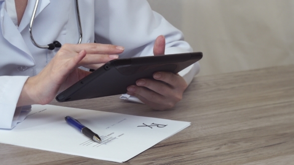 The Doctor Puts The Tablet And Then Fill The Form