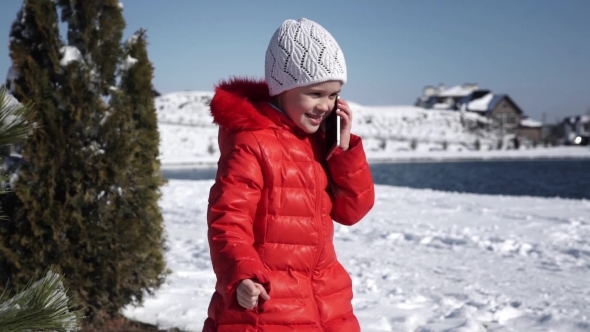 Little Girl In a Red Jacket Talking On The Phone