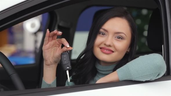 Smiling Woman Showing The Car Key alt