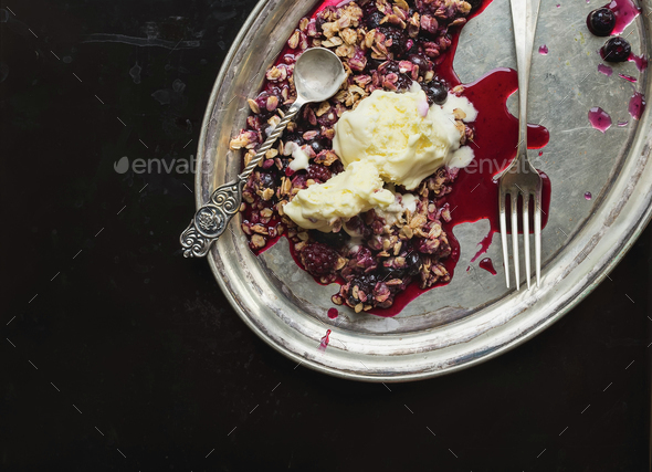 Baked oatmeal with berries and vanilla ice-cream with a tea-spoo - Stock Photo - Images