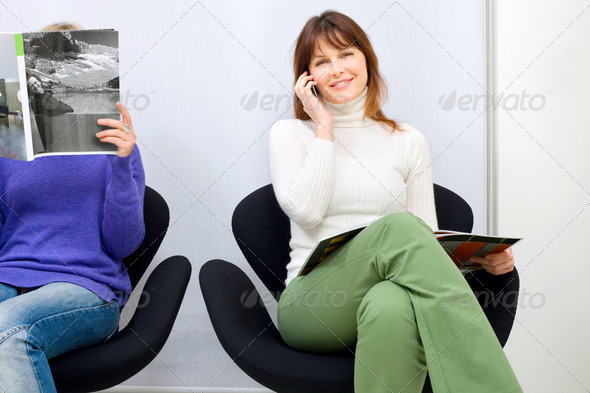 two women sitting in the waiting room for doctors
