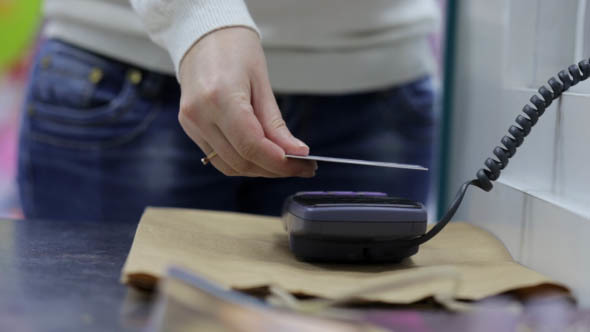 Girl is Shopping, Paying by Credit Card alt