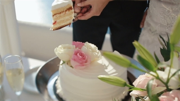 Happy Fabulous Couple Puts a Piece Of Wedding Cake