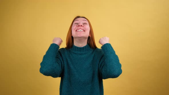 Young Red Hair Woman in Green Sweater Posing Isolated on Yellow Color Background Studio alt