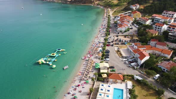Baska Beach, Krk island, Croatia - Aerial Drone View of the Seaside Resort with Coastline, Tourists, alt