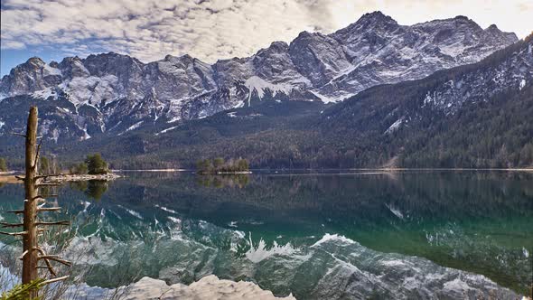 Timelapse of a reflecting mountain lake in the German alps. Eibsee in Bavaria, Germany