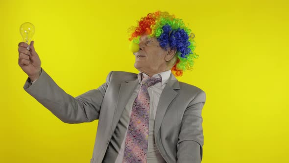Senior Clown Businessman Entrepreneur Show Light Bulb. Came Up with Great Idea alt