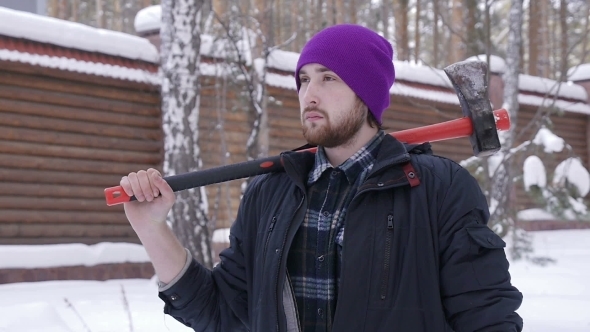 Modern Harsh Lumberjack With An Ax Standing In The Woods