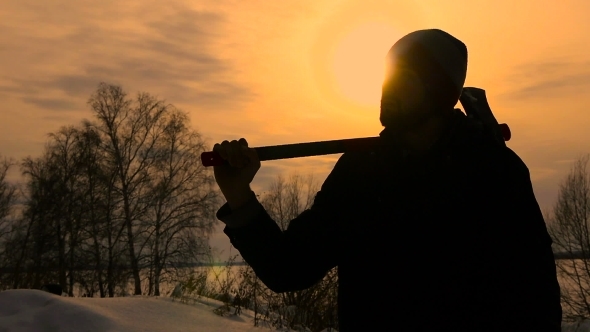 Silhouette Lumberjack Standing With His Ax In Sunset Time