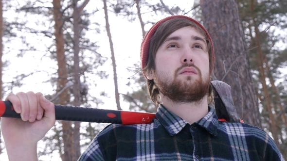 Lumberjack Standing With His Ax In The Woods