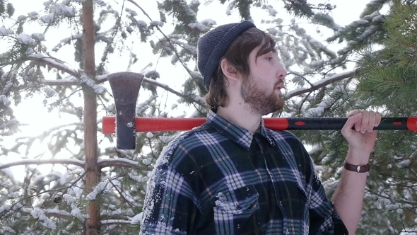Lumberjack Standing With His Ax In The Woods