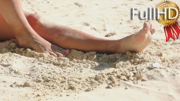 Female Legs Play With Sand on The Beach