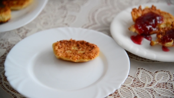 Housewife Puts Cheese Pancakes On Plate