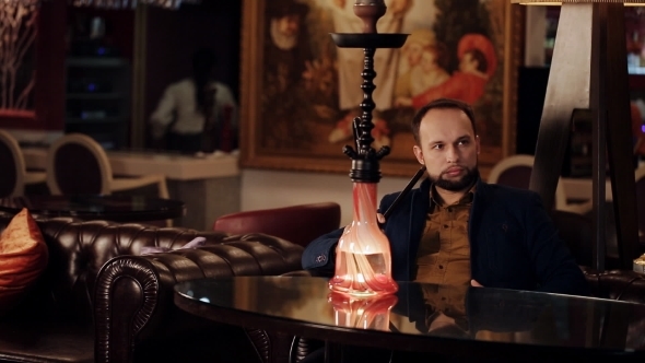 Young Intelligent Man Smoking Hookah alt