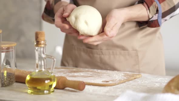 Man Cook Prepares Dough For Making Bread. Kneading The Dough For Making Bread. alt