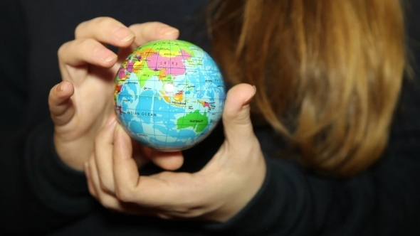 Small Globe In The Hands Of Women