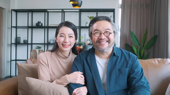 Middle-aged Asian couple smiling for the camera