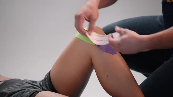 Kinesio Tape on the Girl's Knee alt