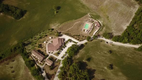 View of a house with swimming pool flown over by a drone, Italian countryside alt